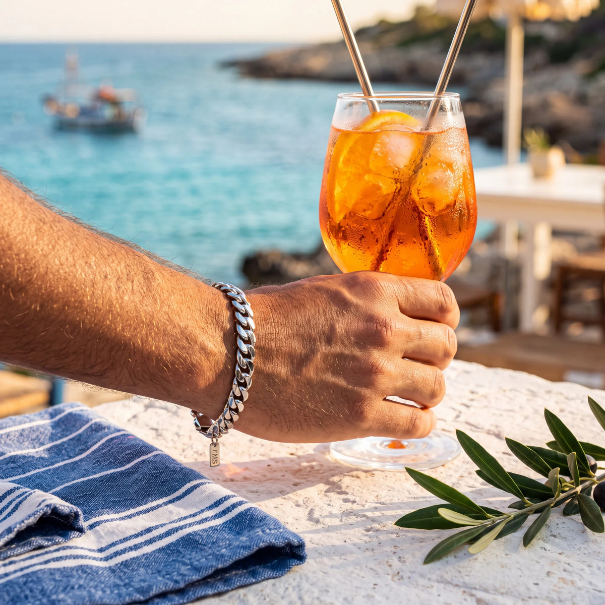 Cuban link bracelet, silver, worn on a terrace by the sea