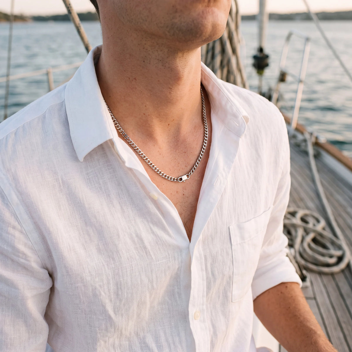 Curb chain necklace, silver, worn on a boat